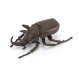 Japanese patinated bronze rhinoceros beetle, impressed character marks to the underside, 10cm in