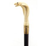 Hardwood walking stick with carved bone pommel in the form of a cobra, 90.5cm in length : For