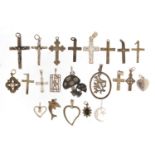 Twenty two silver pendants including crucifixes and love hearts, the largest 5.5cm in length, 39.
