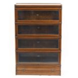 Oak Globe-Wernicke, four tier bookcase with drawer to the base, 135cm H x 87cm x 26cm D : For