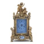 Continental bronze mantel clock with porcelain panels mounted with cherubs. 30cm high : For