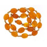 Butterscotch amber coloured bead and unmarked gold necklace, (tests as 18ct gold) 50cm in length,