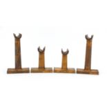 Four antique wooden stands, each with impressed numbers, the largest 22.5cm high : For Further