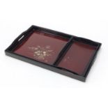 Japanese lacquered three tray set with gold flecking, each decorated with flowers and with twin