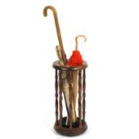 Mahogany stick stand with a selection of walking sticks and umbrellas : For Further Condition