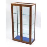Oak glazed two door display cabinet fitted with three adjustable shelves, 122cm H x 69cm W x 35cm
