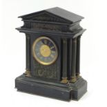 Victorian black slate mantel clock with bronzed Corinthian pillars the circular dial having Roman