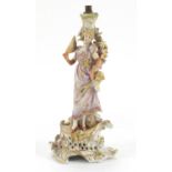 German porcelain figural candlestick encrusted with flowers by Plaue, numbered 576 75, 27.5cm high :