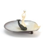 Art Deco abalone centrepiece mounted with a nude carved ivory female, knelt on a bronzed fish,