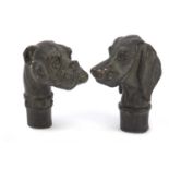 Two patinated bronze dog head design walking stick handles, the largest 7.5cm high : For Further