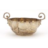 Continental silver circular bowl with twin handles and embossed with flowers, indistinct impressed