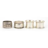Four Victorian and later circular silver napkin rings, various hallmarks, the largest 5cm in