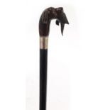 Ebonised walking stick with silver collar and pommel carved in the form of a dog with it's catch,