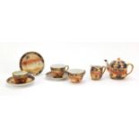 Noritake teaware hand painted with desert scenes including teapot and two cups with saucers, the