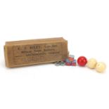 Three turned ivory billiard balls, one stained red, housed in E J Riley box, each 4.5cm in