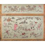 Chinese silk panel embroidered with two figures amongst flowers in a landscape below two Foo dogs,