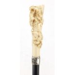 Ebonised Tyrolean walking stick with ivory pommel, finely carved with two huntsmen chasing a stag