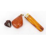 Butterscotch amber coloured cheroot with 18ct gold mount and two amber pendants, the largest 7cm