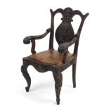 Chinese hardwood armchair with brown leather seat profusely carved with dragons, 104cm high : For