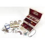 Vintage and later costume jewellery arranged in a jewellery box including silver rings, coral,