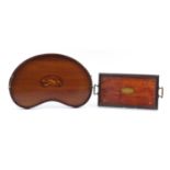Two mahogany trays including an Edwardian inlaid kidney shaped example with brass handles, the