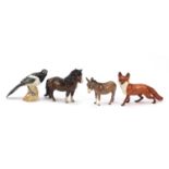 Four Beswick collectable animals comprising a fox, magpie, donkey and pony, the largest 25cm
