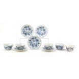 Five Meissen fluted cups and saucers hand painted in the Blue Onion pattern, crossed sword marks