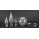 Antique glassware including three large decanter stoppers, two inkwells and an eyebath, the