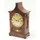 Regency mahogany pagoda topped bracket clock with inset brass panel to the front, flower head design