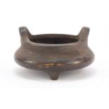 Chinese patinated bronze tripod incense burner, character marks to the base, 14cm in diameter :