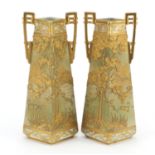 Pair of Noritake porcelain vases with twin handles gilded and decorated in relief with landscapes,