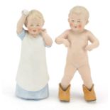 Pair of 19th century bisque figures of children, the largest 21.5cm high : For Further Condition