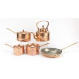 Copper kitchenalia including graduated set of three saucepans and a kettle, the largest 39cm in