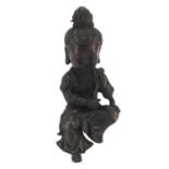 Chinese patinated bronze figure of a seated girl holding a flower, character marks to the reverse,