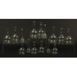 Fifteen early 20th century glass Chemist's flasks or retorts, the largest each 19.5cm high : For