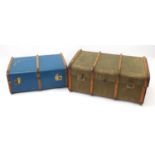 Two vintage cabin trunks including a canvas bound example, each with leather carrying handles, the