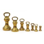 Seven Victorian brass bell weights, the largest 23cm high : For Further Condition Reports, Please