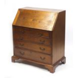Oak bureau, the fall enclosing a fitted interior above four graduated drawers, on bracket feet,