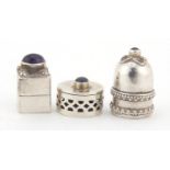 Three silver trinket boxes including one set with a cabochon amethyst, the largest 3cm high, 32.5g :