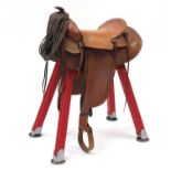 Vintage American leather saddle on a display stand, 96cm high : For Further Condition Reports,