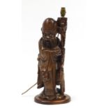 Chinese carved root wood lamp in the form of an Elder holding a peach, 55cm high : For Further