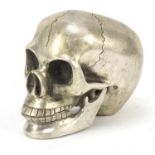 Silvered bronzed model of a human skull with articulated jaw, 9.5cm high : For Further Condition