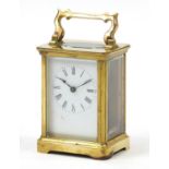 French gilt brass carriage clock, white enamel dial with black painted Roman numerals, raised on