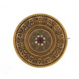 Victorian unmarked gold mourning brooch (tests as 15ct gold) set with seed pearls and a red stone,