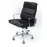 Chromium E Soft Pad easy chair by ICF raised on splayed feet terminating in five plastic casters,