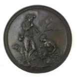 19th century patinated bronze plaque cast with a shepherd, shepherdess, sheep dog and sheep, 23cm