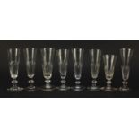 Eight 18th/19th century Champagne flutes with faceted bowls and knopped stems, the largest 17.5cm