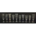 Ten 18th/19th century Champagne flutes with faceted bowls including one with blade collar and double