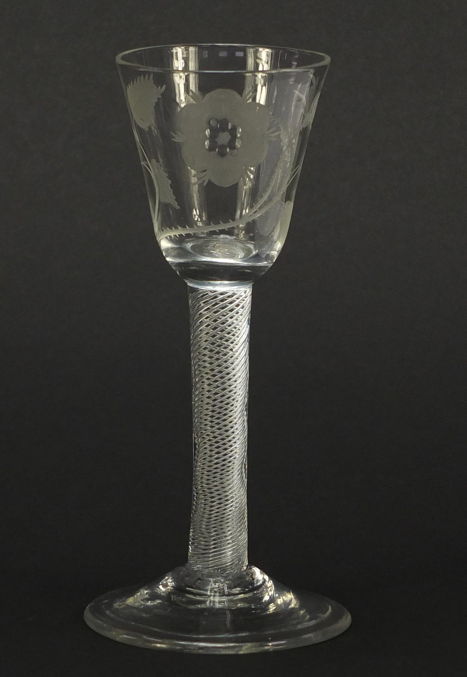 18th century Jacobite wine glass having a rounded funnel bowl engraved with a rose and foliage, on