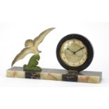 French Art Deco marble and onyx desk clock mounted with a bronzed bird in flight, the circular